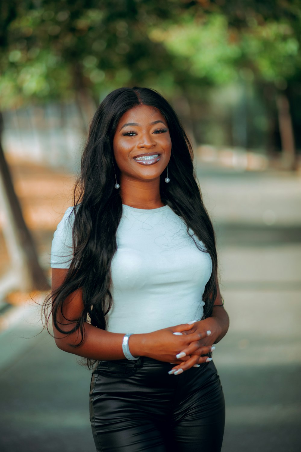 a woman in a white shirt and black pants