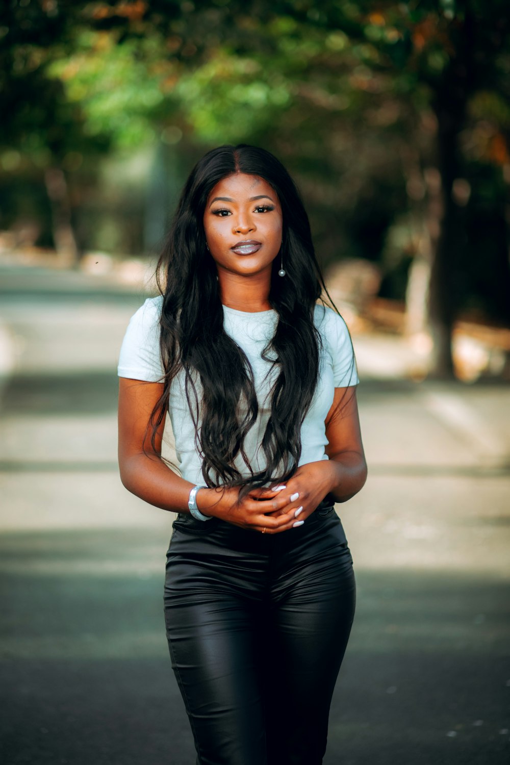 a woman in black pants and a white shirt