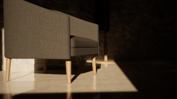 A plush, modern gray sofa with clean lines and wooden legs in a bright living room.