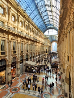 a group of people walking around inside of a building