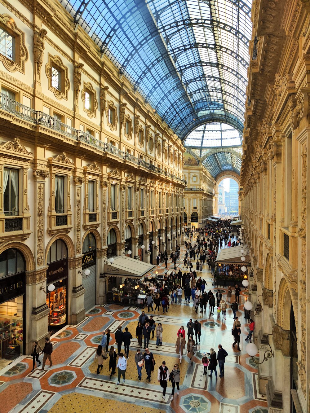 a group of people walking around inside of a building