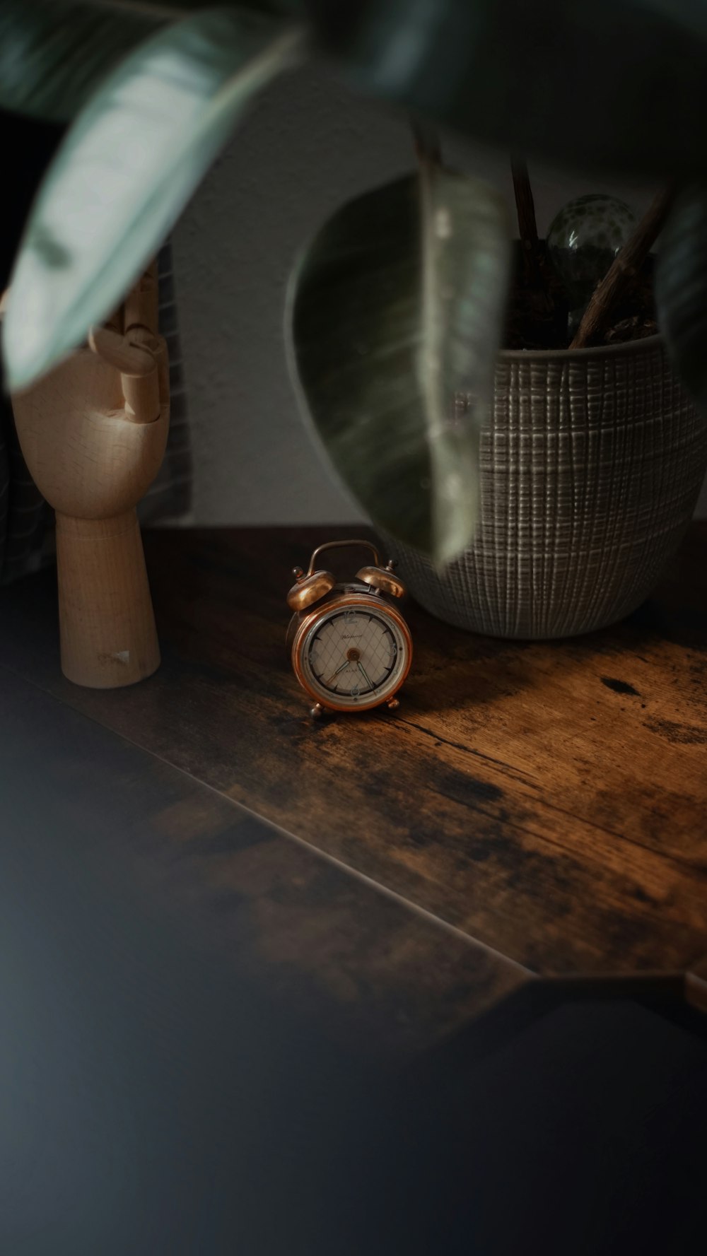 an alarm clock sitting on top of a wooden table