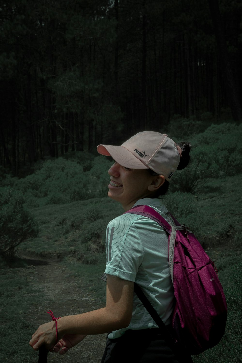 a woman with a pink backpack and a pink hat