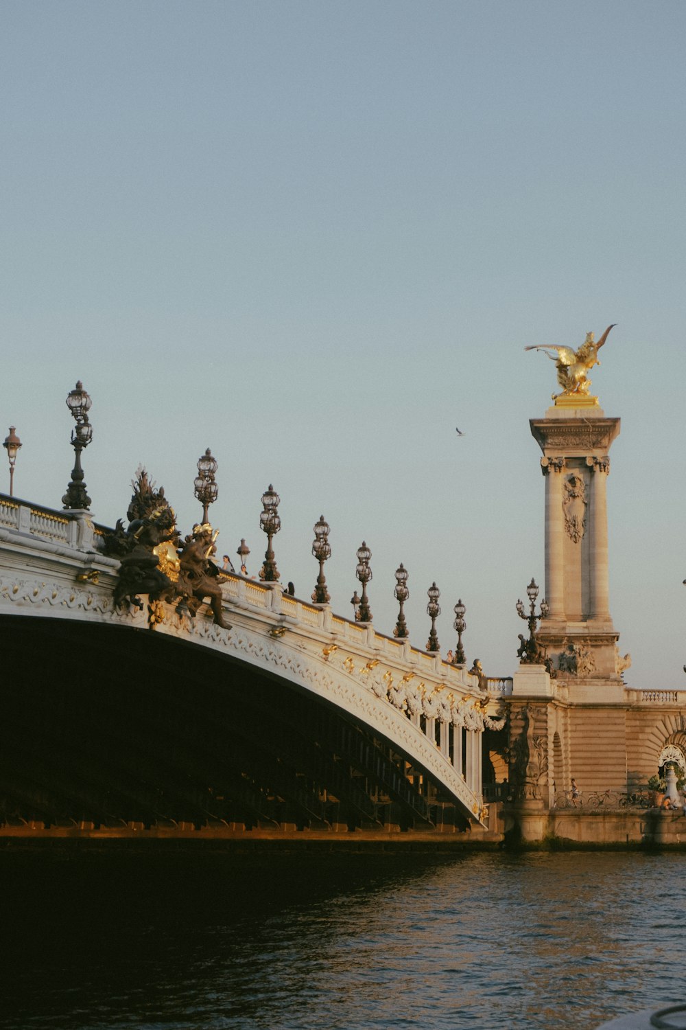 a bridge that has a statue on top of it