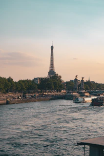 The Eiffel Tower reflected in the Seine River at sunset, Paris.