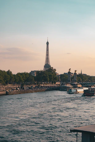 The Eiffel Tower reflected in the Seine River at sunset, Paris.
