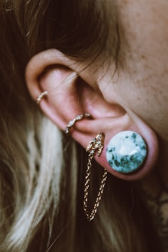 Close-up of a fresh piercing with a bright orange jewel.