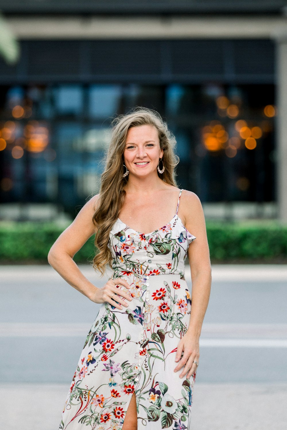 a woman in a floral dress posing for a picture