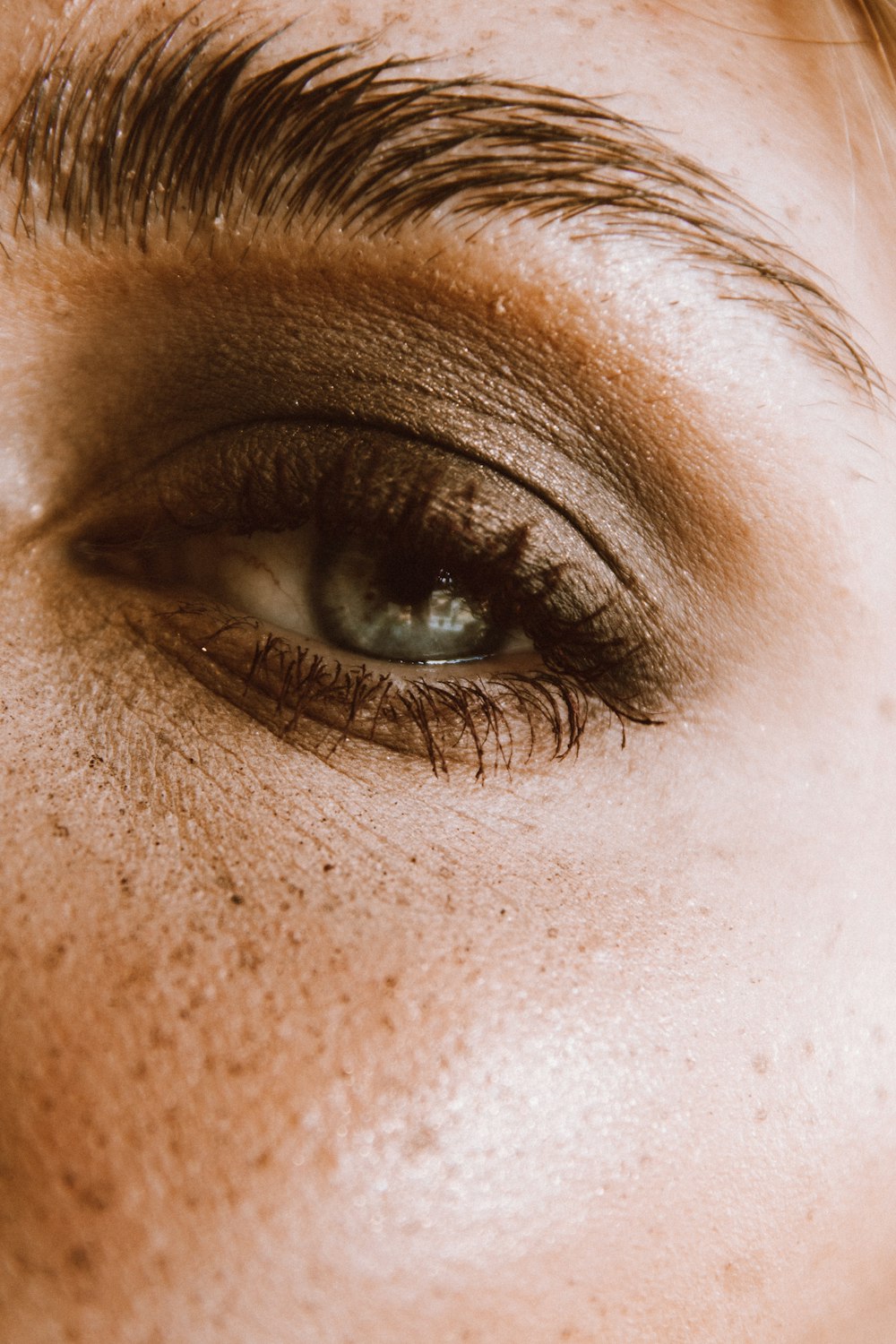 a close up of a woman's eye with frecks