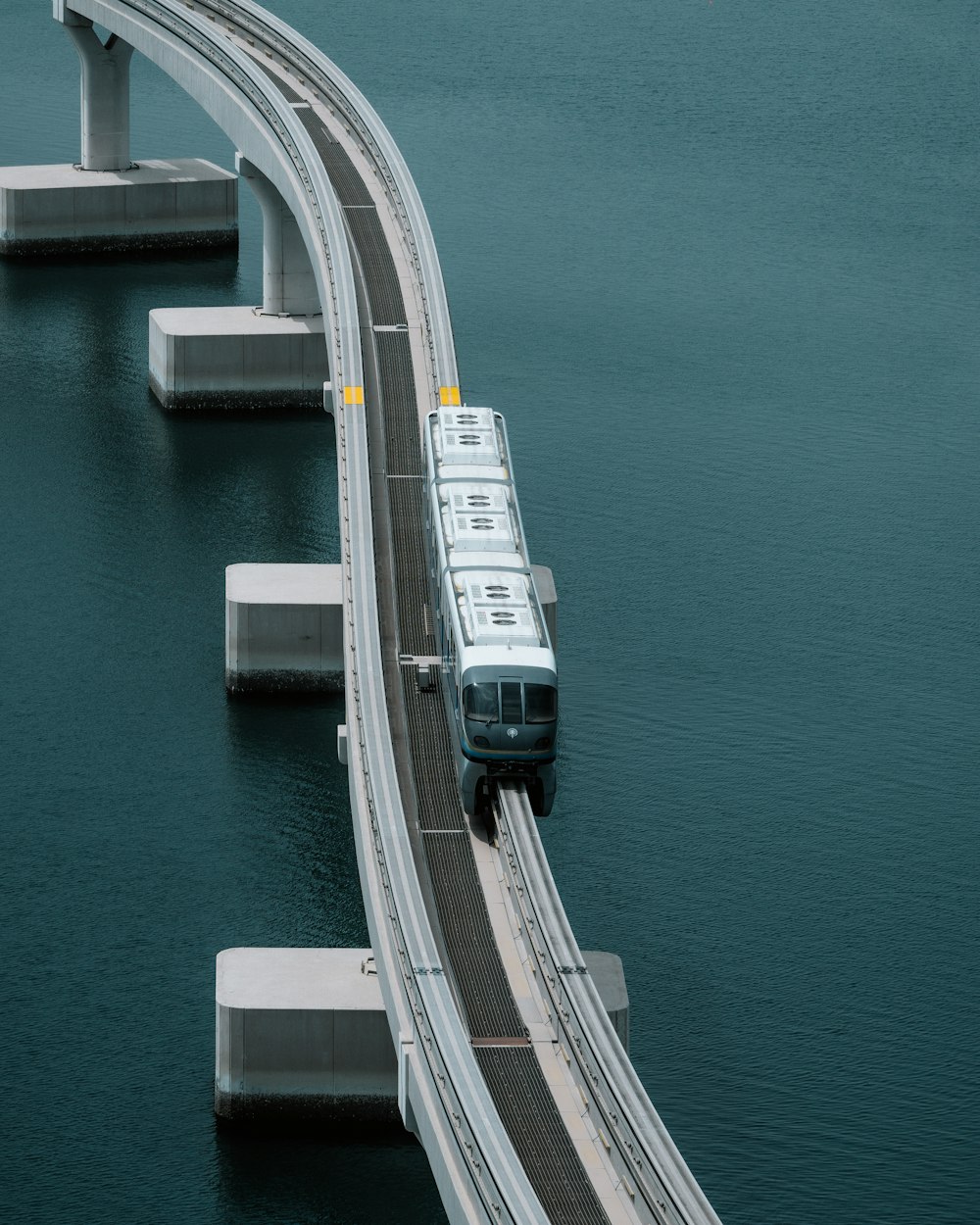 a train on a bridge over a body of water