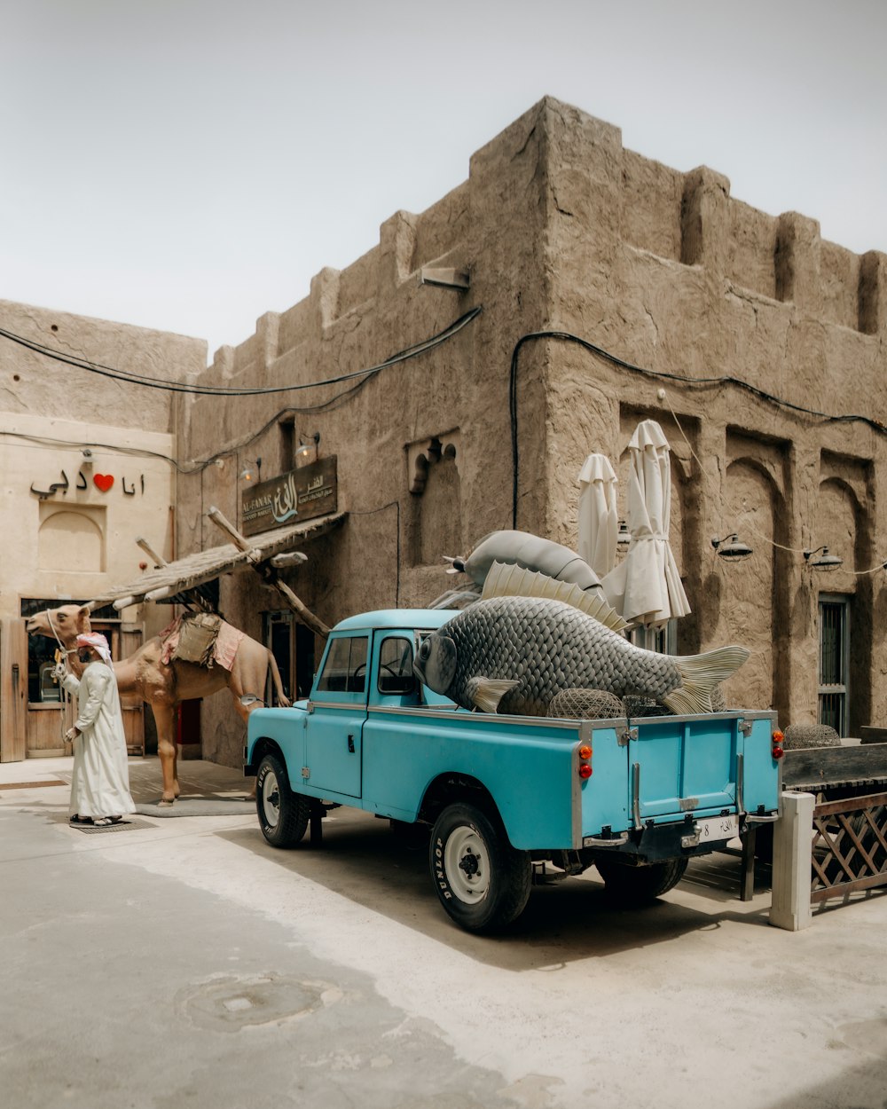 a blue truck parked in front of a building