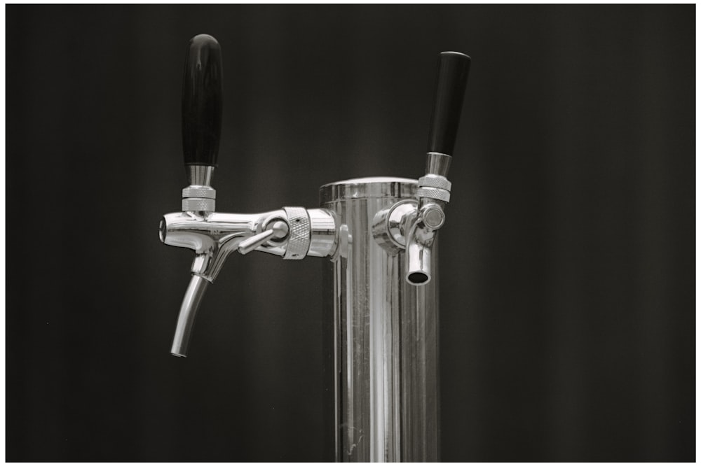 a black and white photo of a faucet