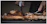 Close-up of a chef carefully using a digital thermometer on a sizzling steak.