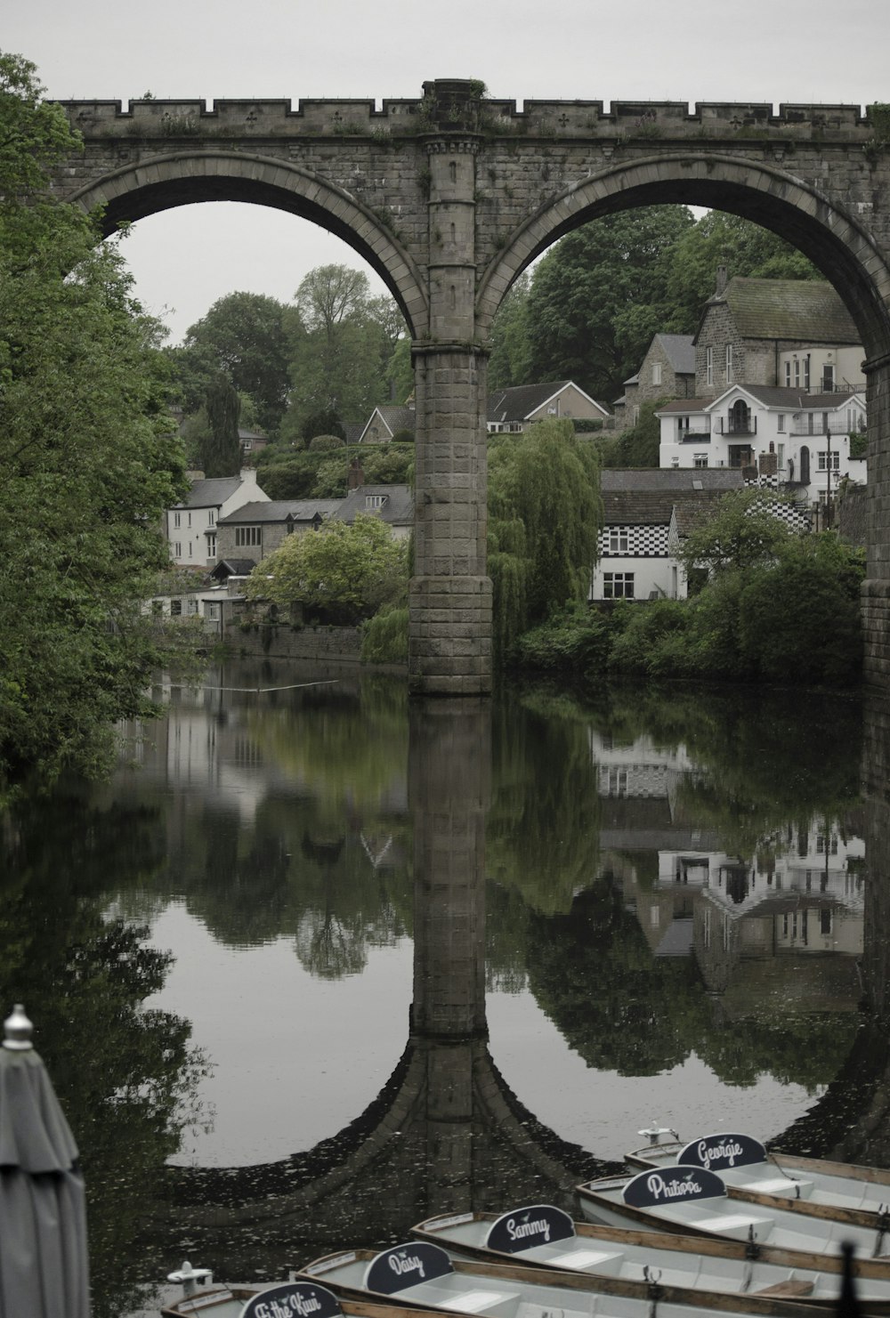 a bridge over a body of water with boats in it