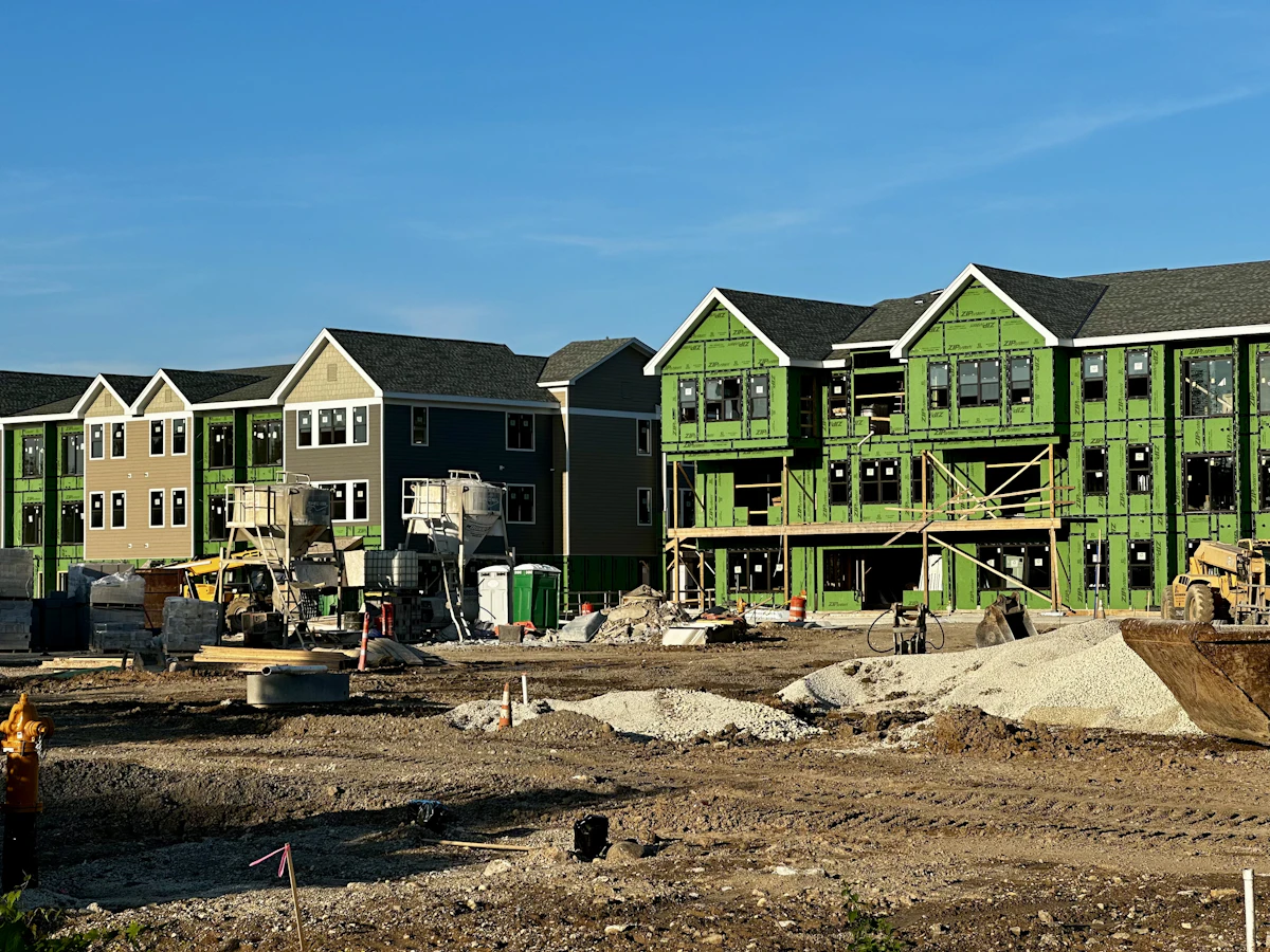 A row of new townhomes under construction in a residential development