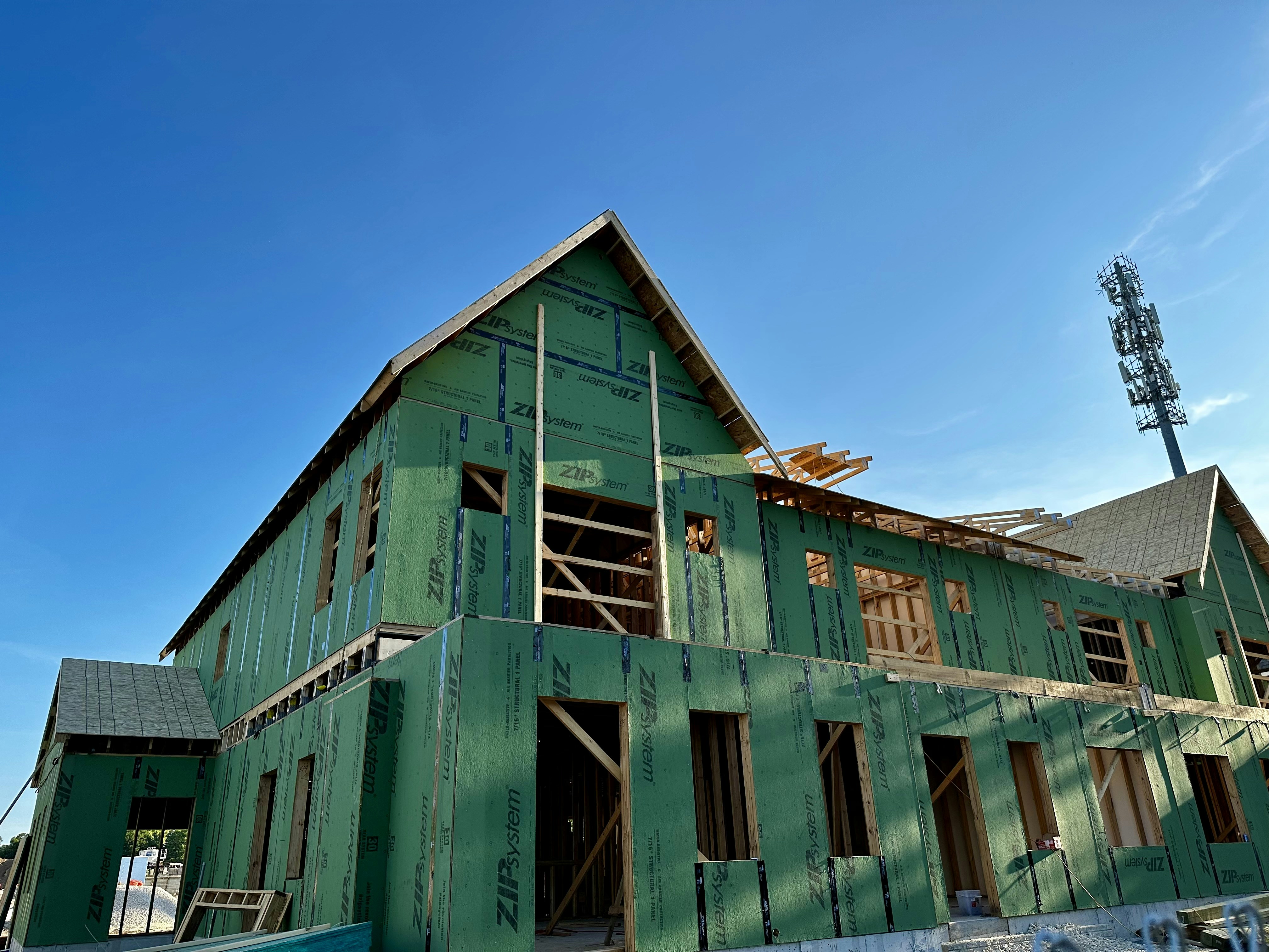 a house under construction with a blue sky in the background