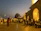 Evening scene of a lively Cuban street with musicians playing and dancers moving joyfully under glowing lanterns.