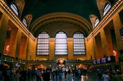 Large train station concourse bustling with commuters.