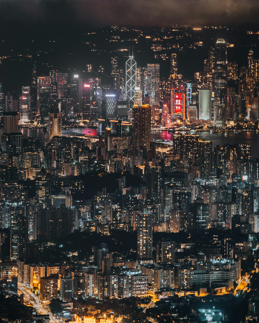 a view of a city at night from the top of a hill