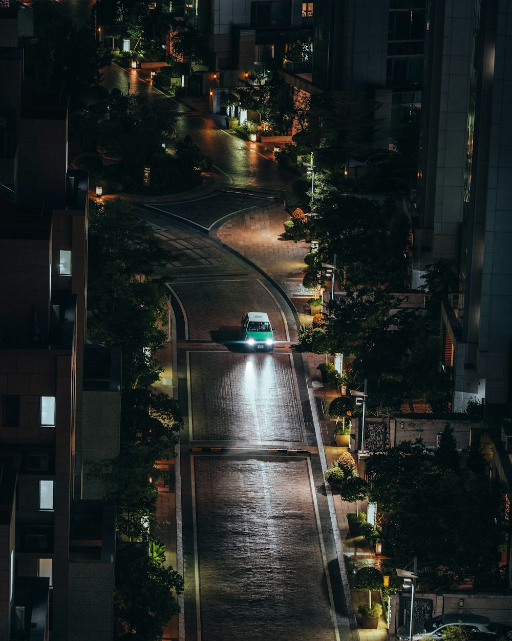 a car driving down a street at night