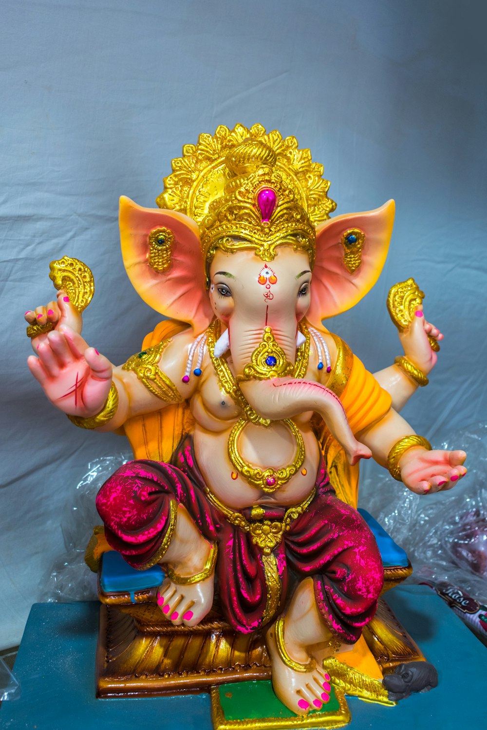 a statue of a ganesha sitting on top of a table