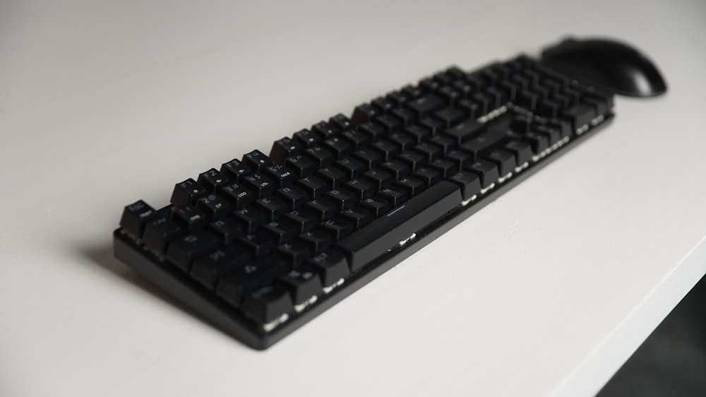 a computer keyboard sitting on top of a white table