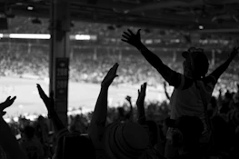 Dynamic shot of a vibrant sports event with excited spectators in a community venue.