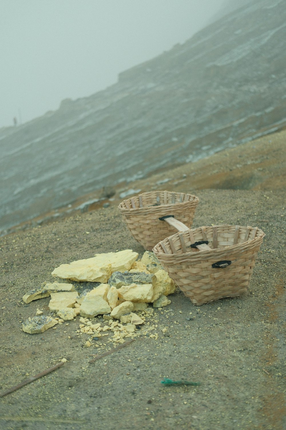 a couple of baskets sitting on top of a sandy beach