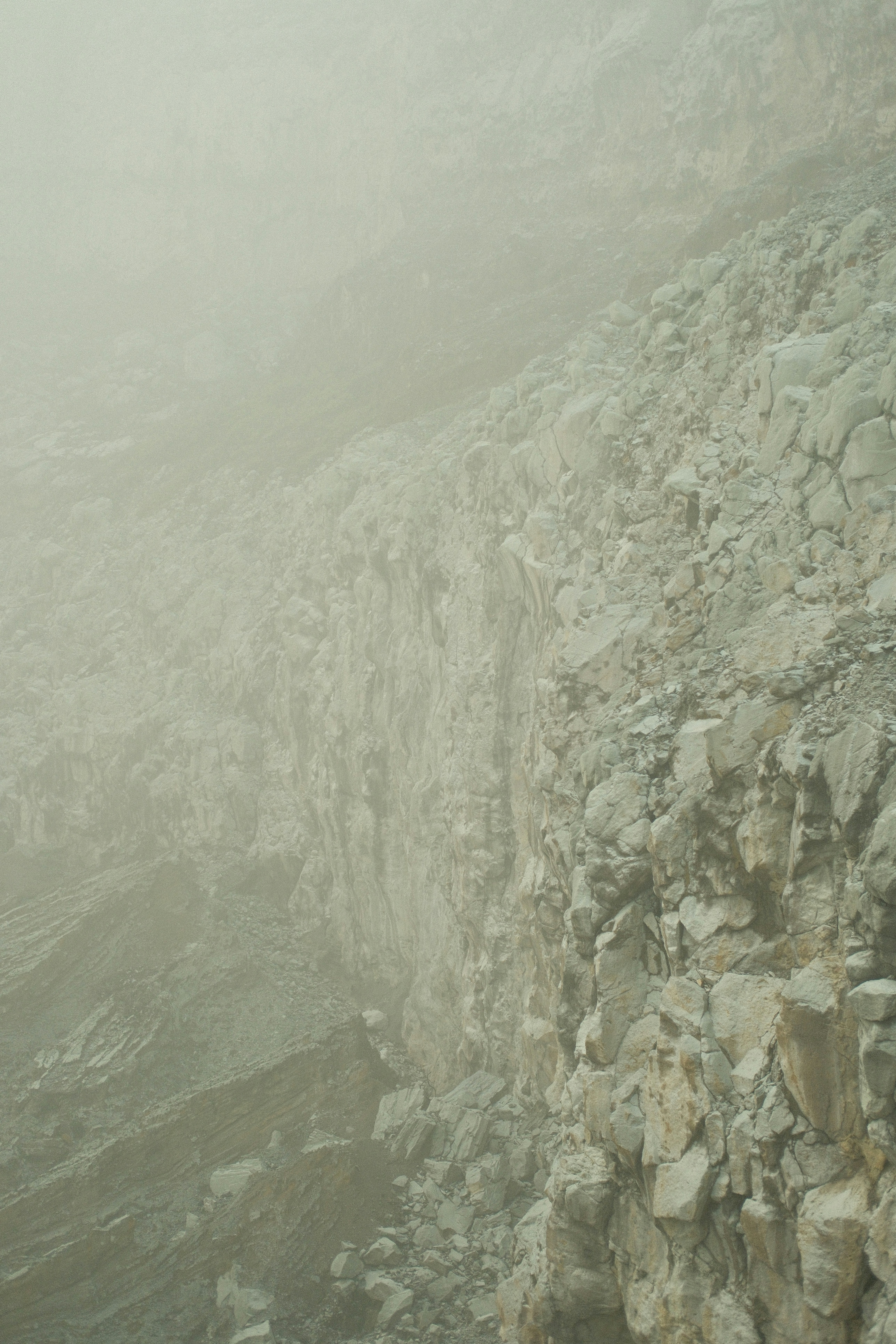 a man standing on top of a rocky cliff