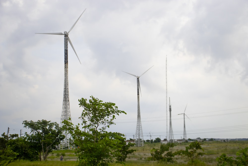 a group of wind turbines on a cloudy day