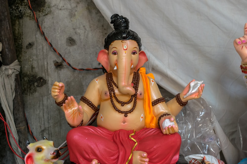 a statue of an elephant sitting on top of a table