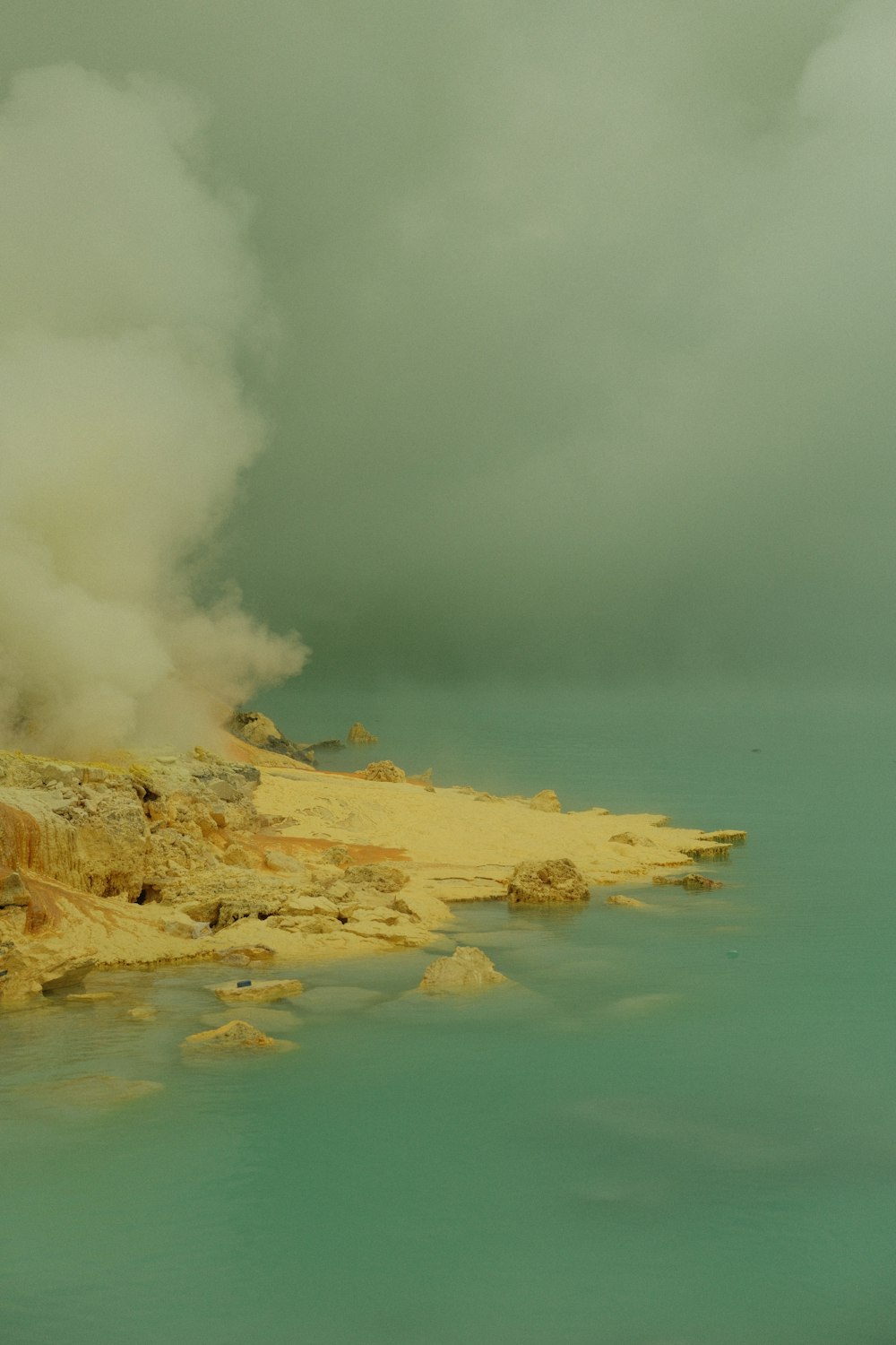 a body of water with steam coming out of it