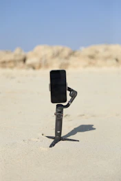 Lifestyle shot of a person using the magnetic lid on the beach, phone attached securely.
