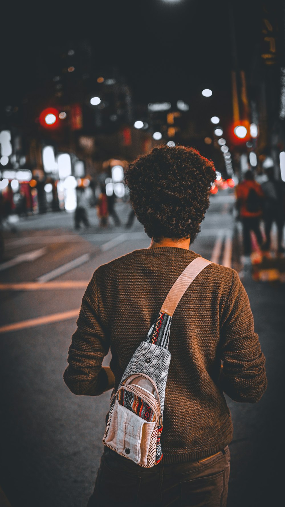 a person walking down a street at night