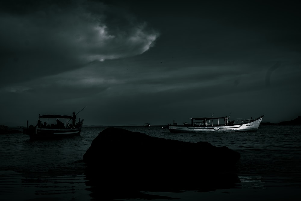 a couple of boats floating on top of a body of water