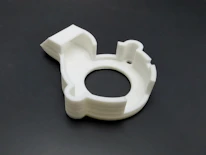Close-up of a detailed 3D printed gadget with neon turquoise highlights on a graphite gray background.