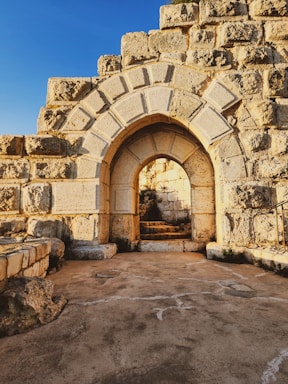 A serene stone archway bathed in warm sunlight, symbolizing welcome and timeless strength.