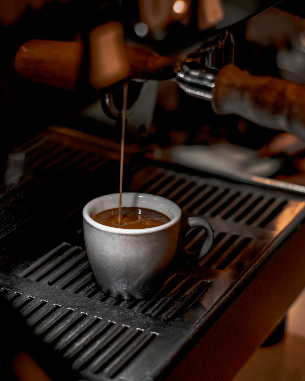 a cup of coffee being poured into it