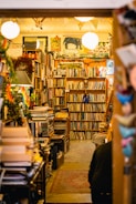 People attending a lively cultural workshop in a warmly lit bookstore space