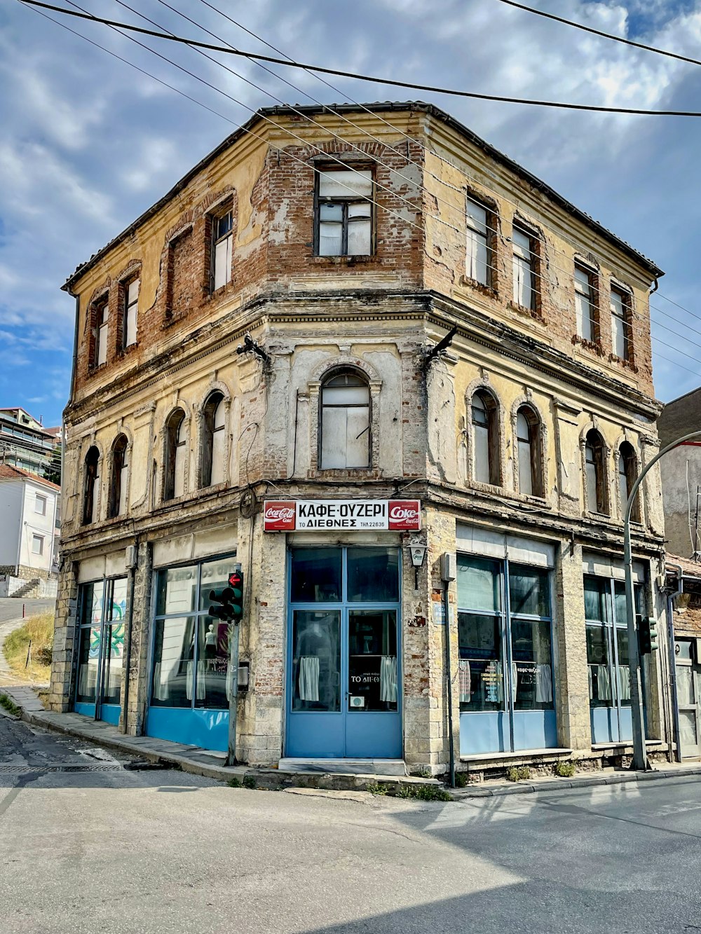 an old building with a blue door on a street corner