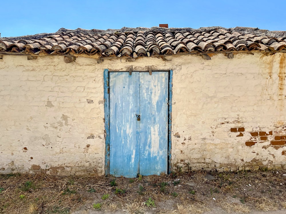 a blue door sits in front of a white building