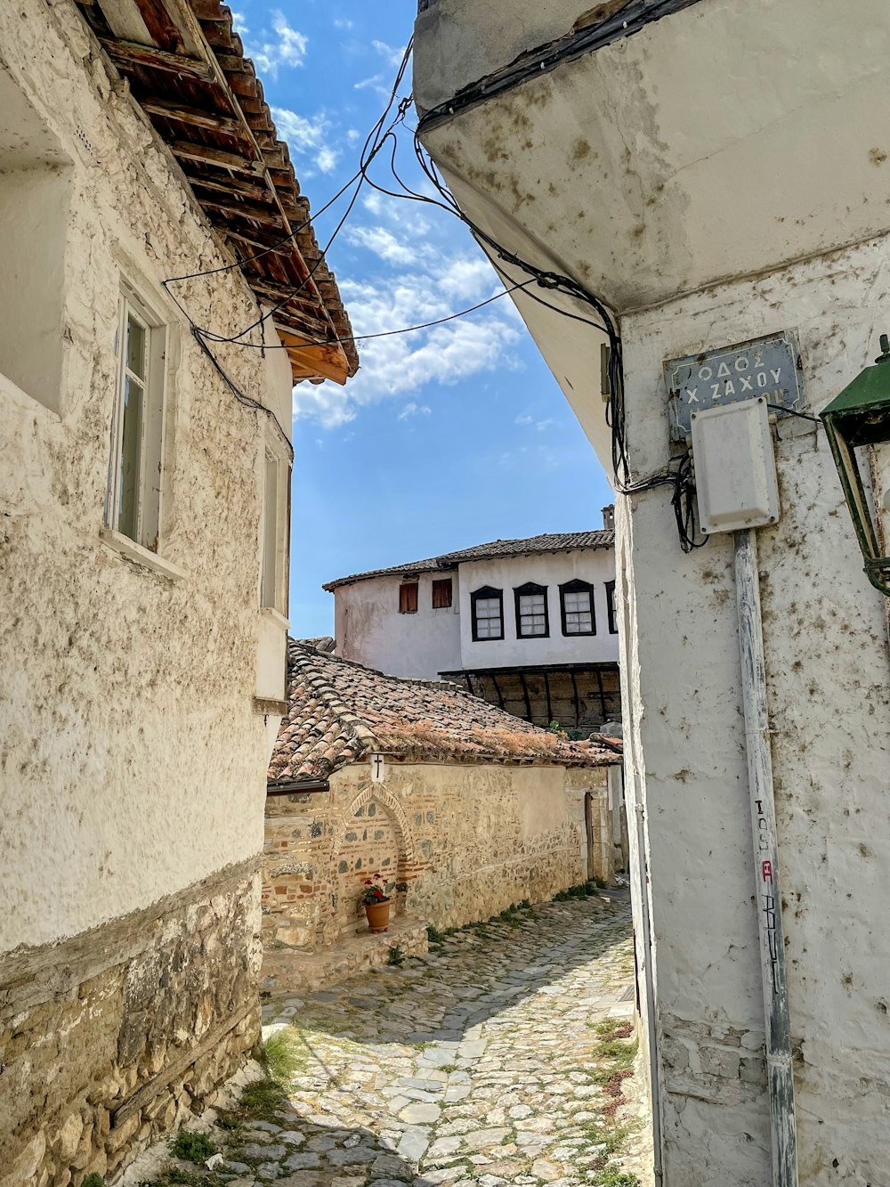 a cobblestone street with a building in the background