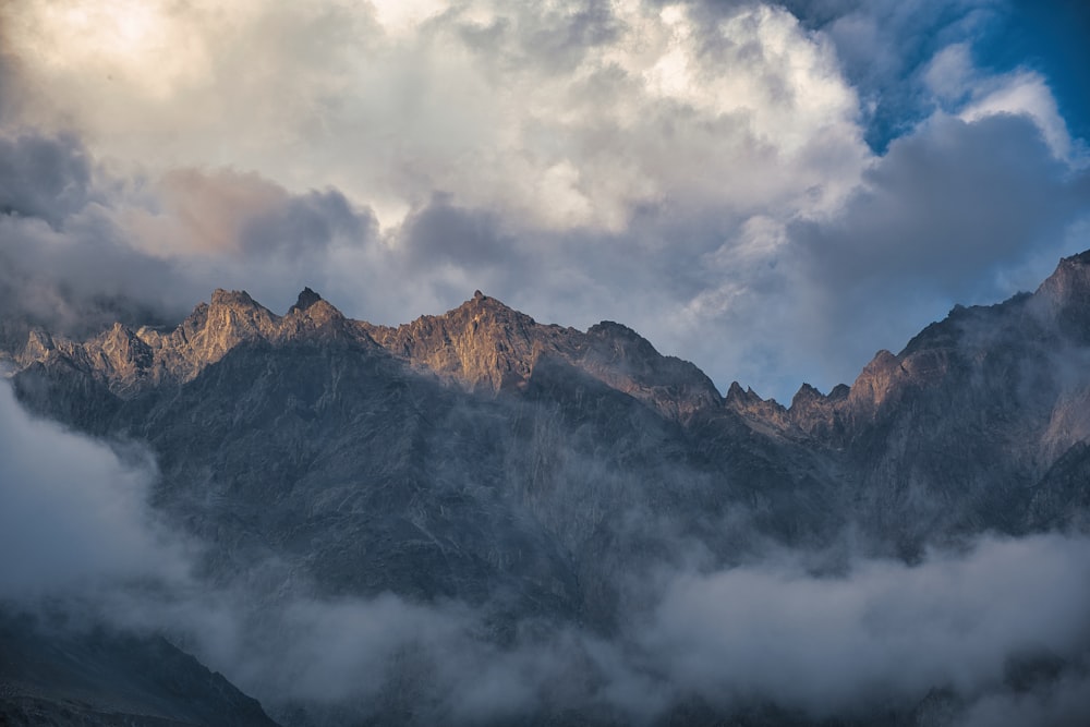 a view of a mountain range covered in clouds