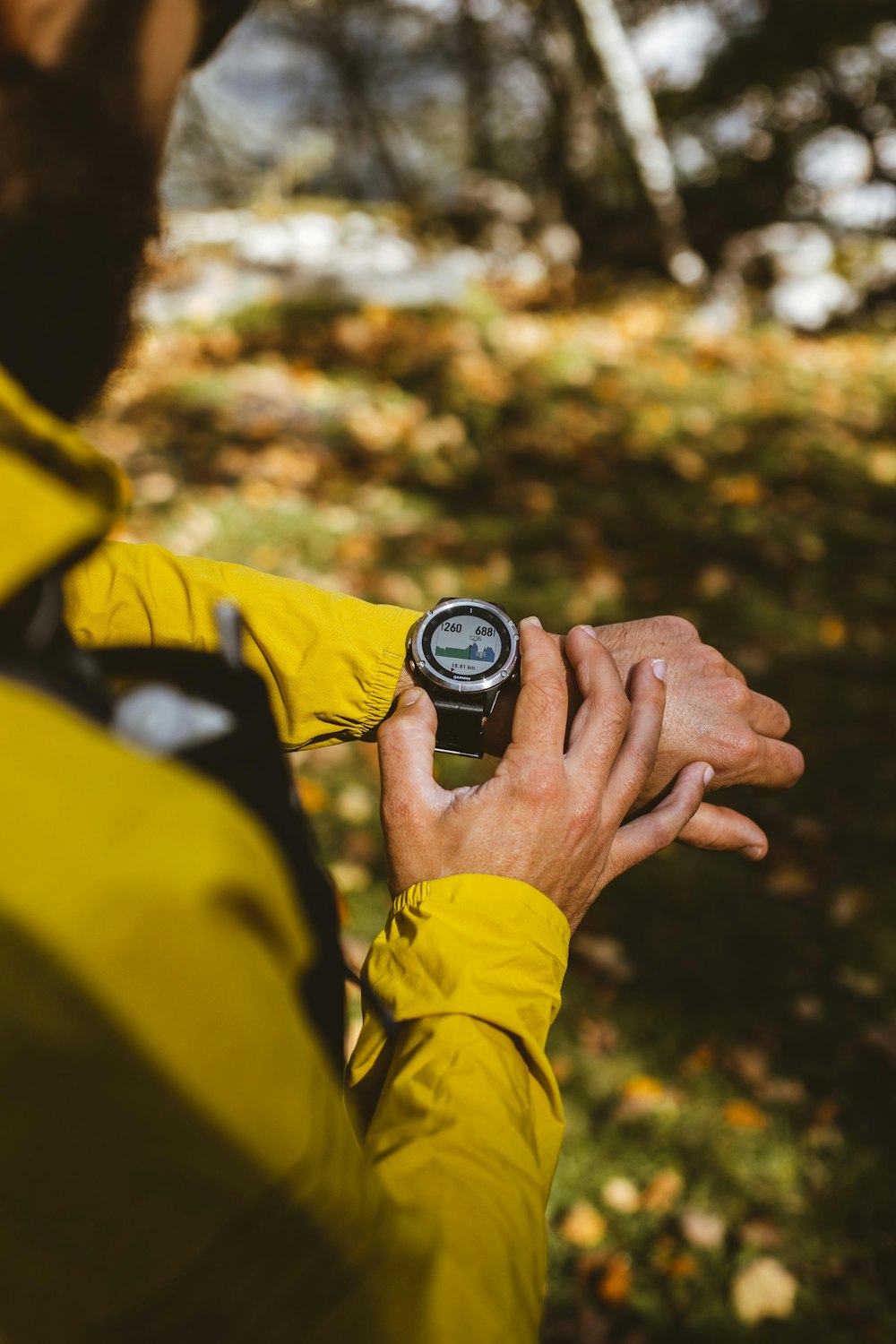 a man in a yellow jacket holding a compass