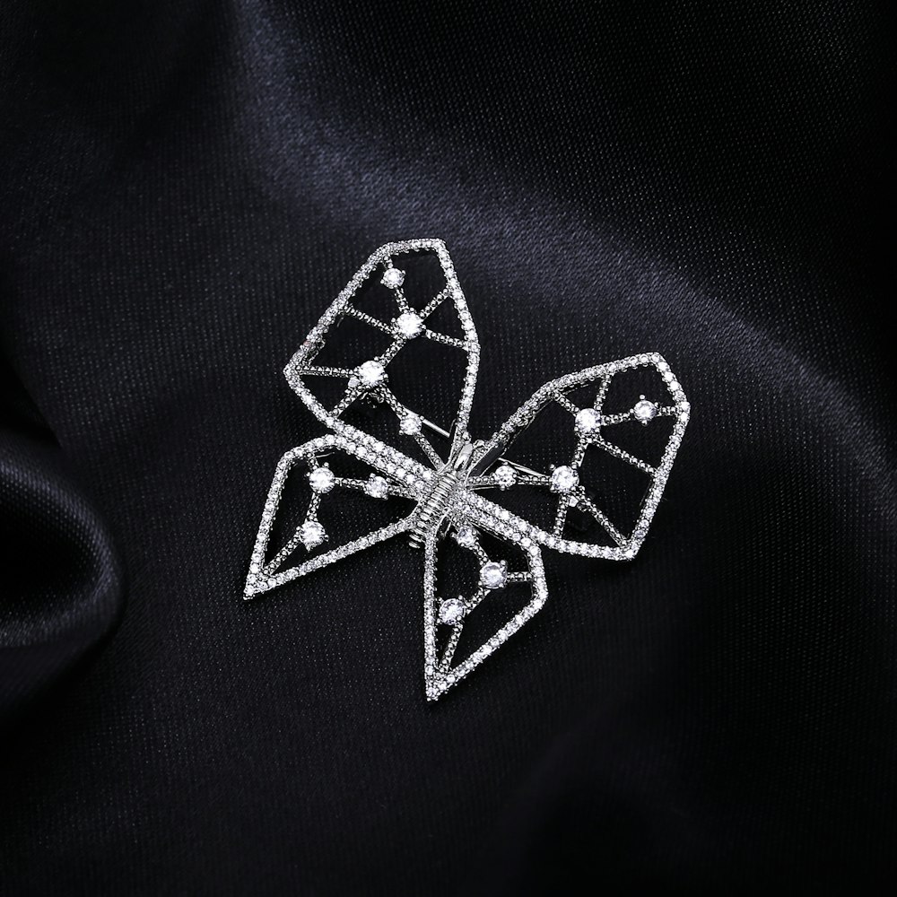 a close up of a brooch on a black cloth