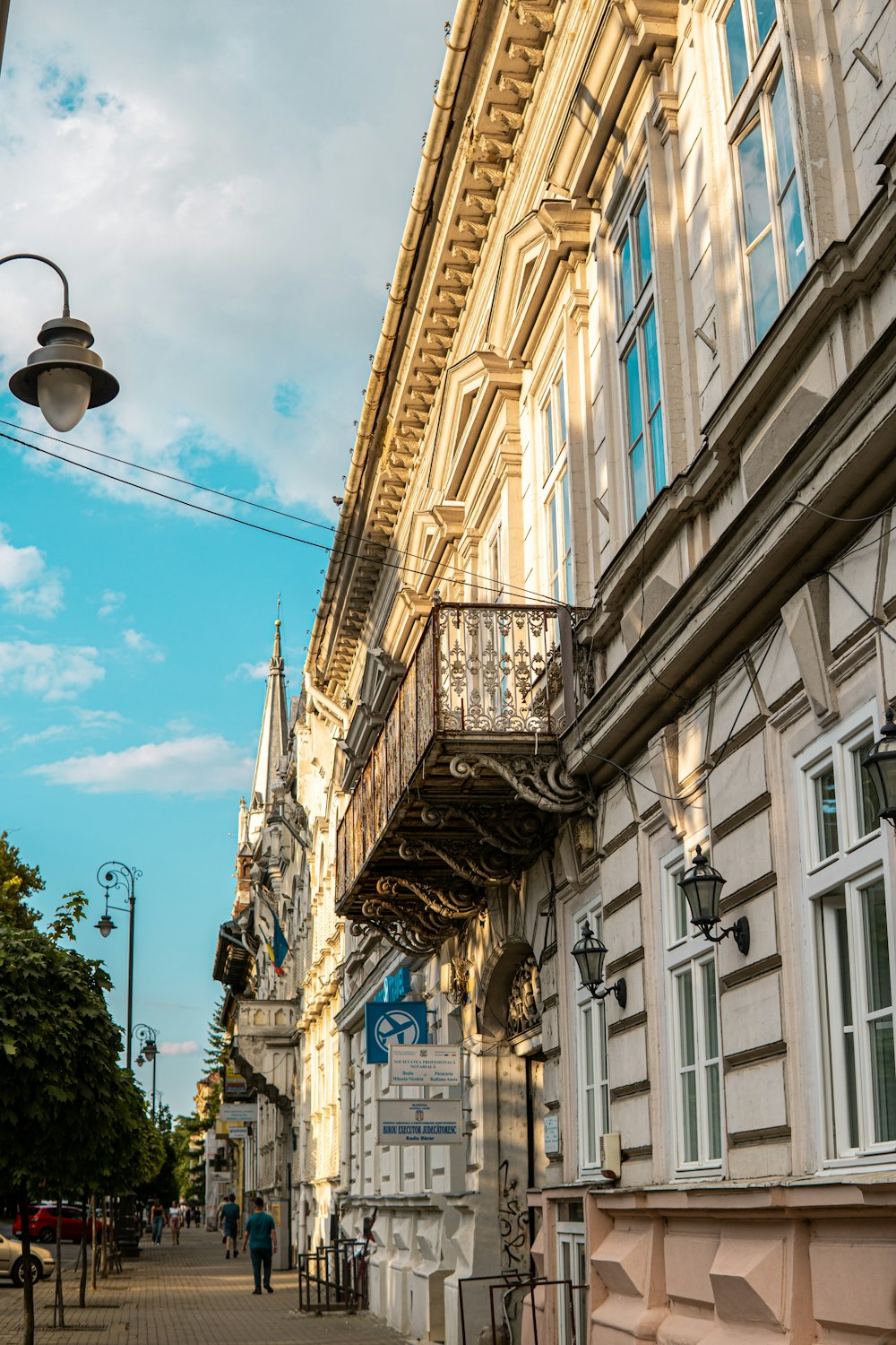 a building with a balcony next to a street