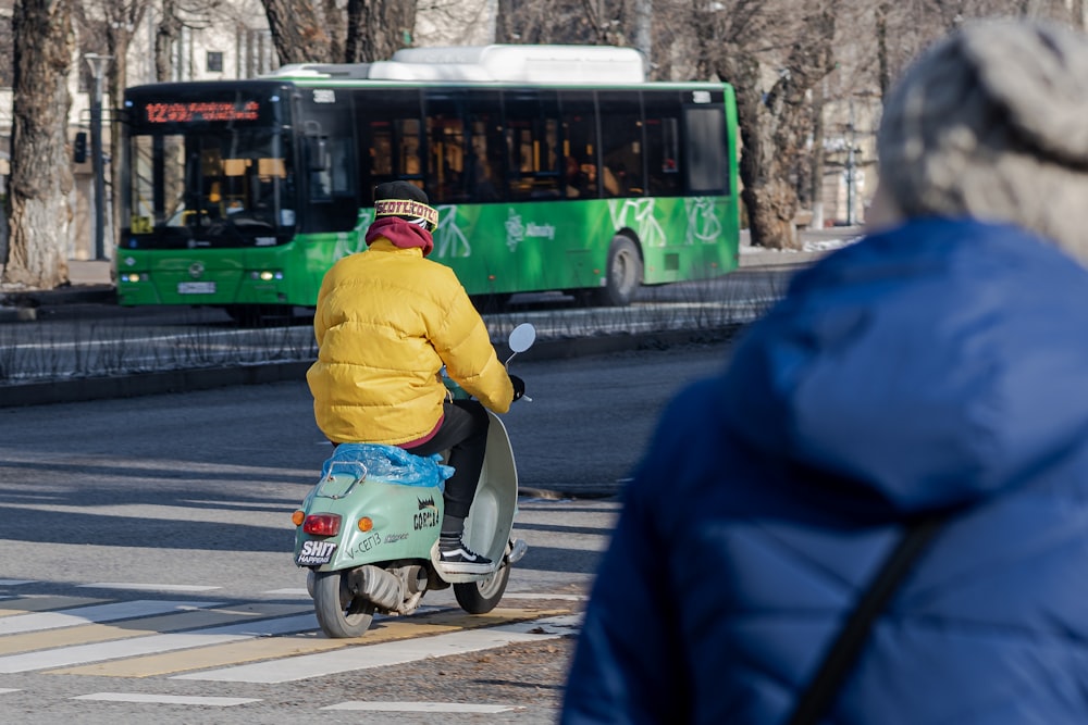 a person riding a scooter on a city street