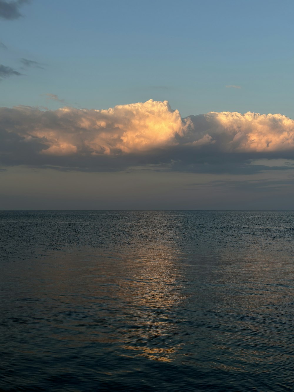 a large body of water under a cloudy sky