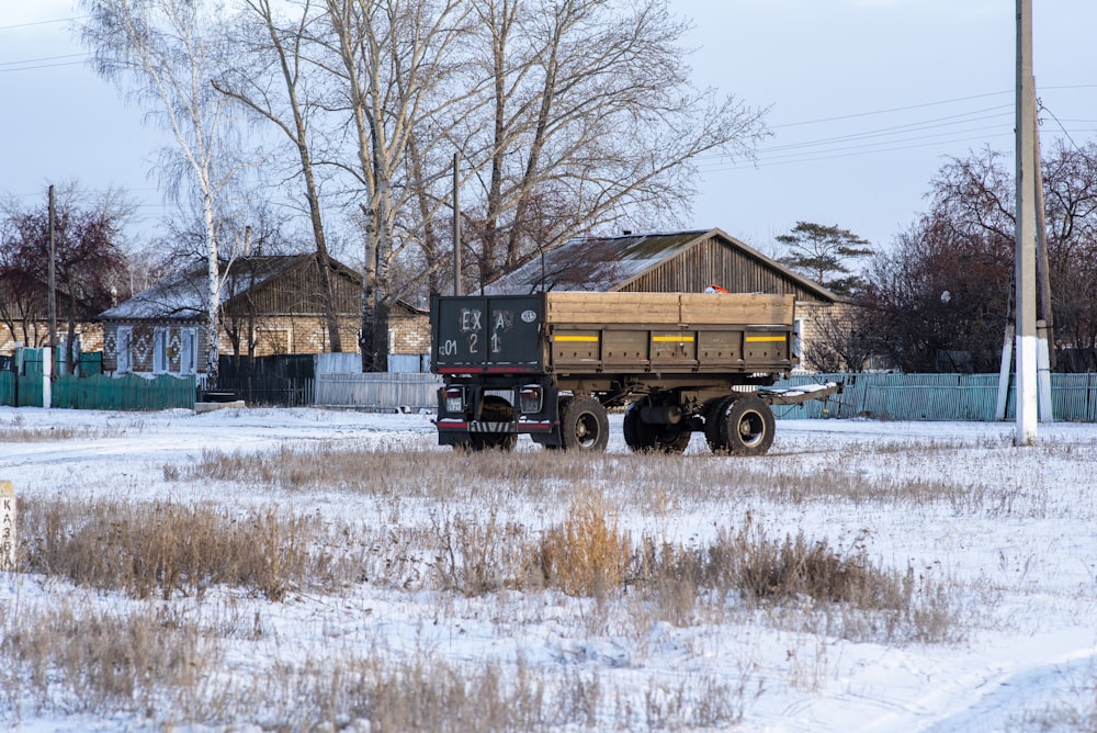 a large truck is parked in a snowy field
