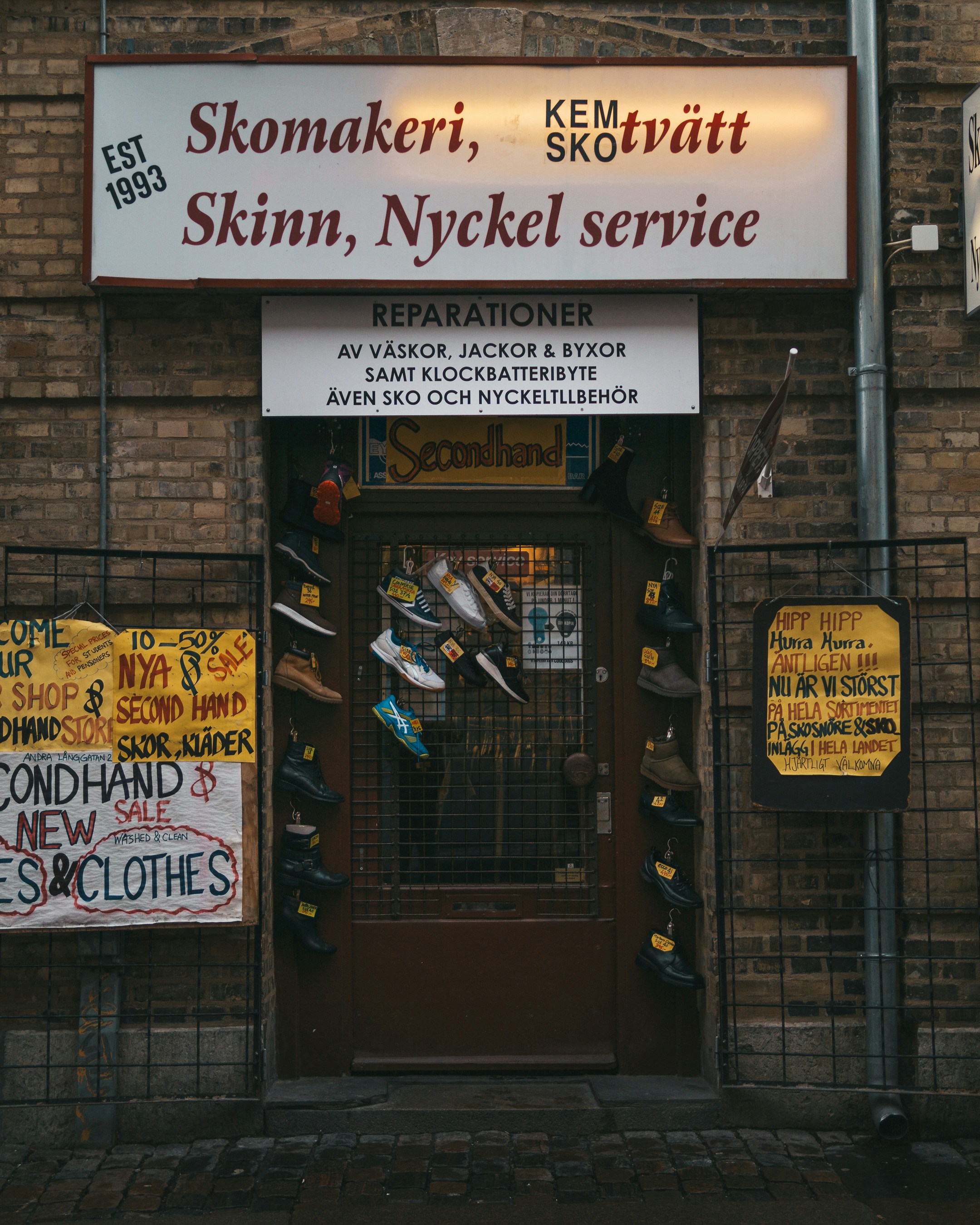a store front with a lot of signs on it